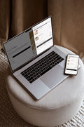 Laptop and smartphone on a stool with a cart drawer, free shipping bar and cart checkbox on the screen